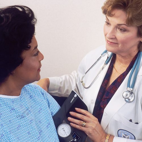 a woman with a stethoscope talking to another woman